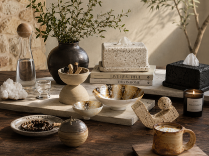 Decorative table setting with various home decor items including a vase, books, and a mug.