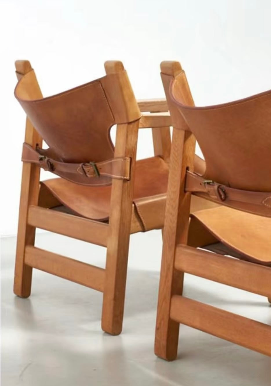 Side profile of Spanish Lounge Chair showing wide armrests and adjustable buckle straps.