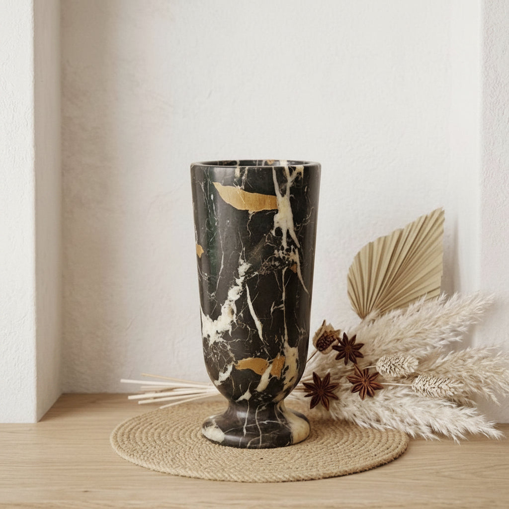 Marble-patterned vase on a wooden surface with decorative elements