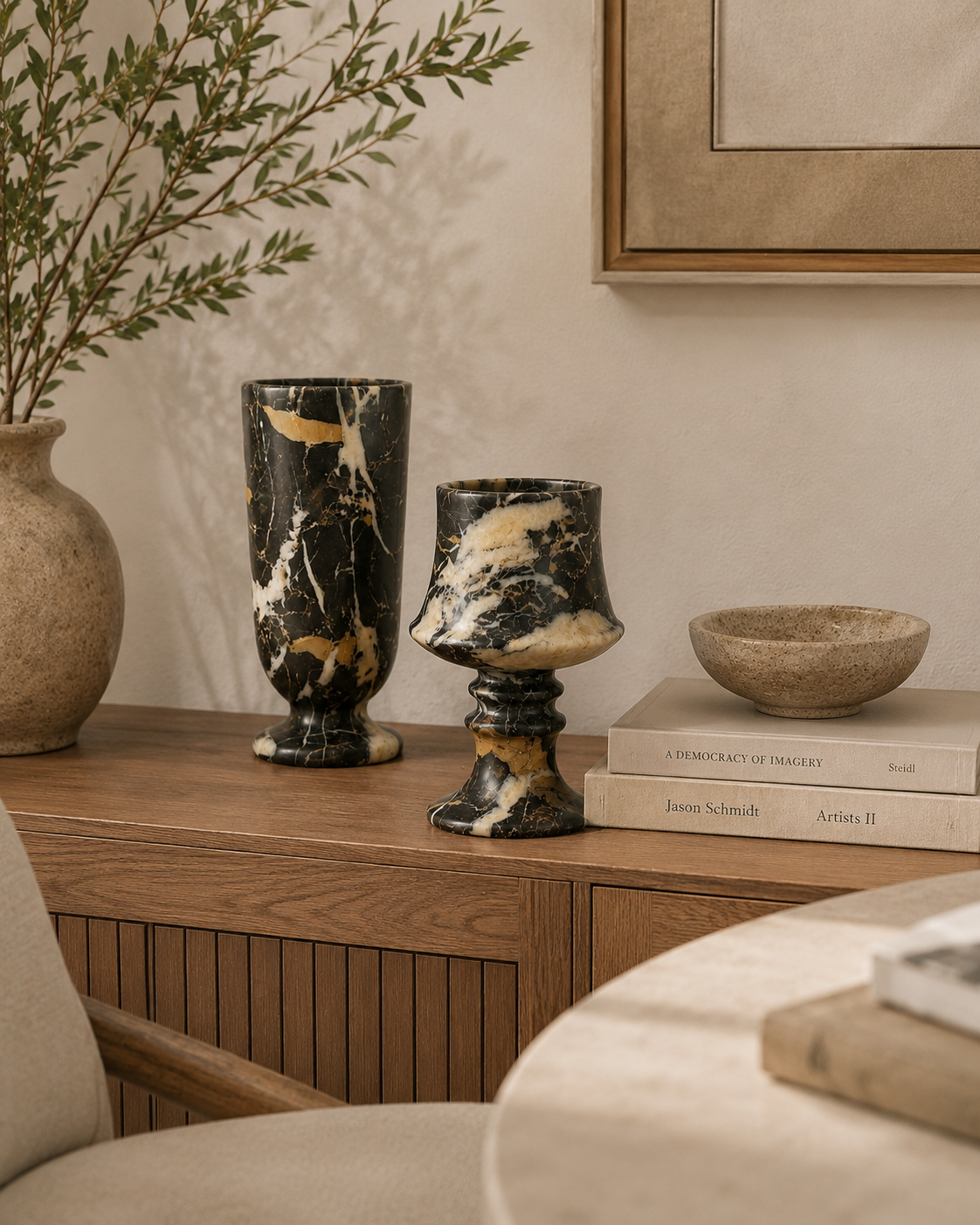 Decorative vases and bowls on a wooden surface with a neutral background