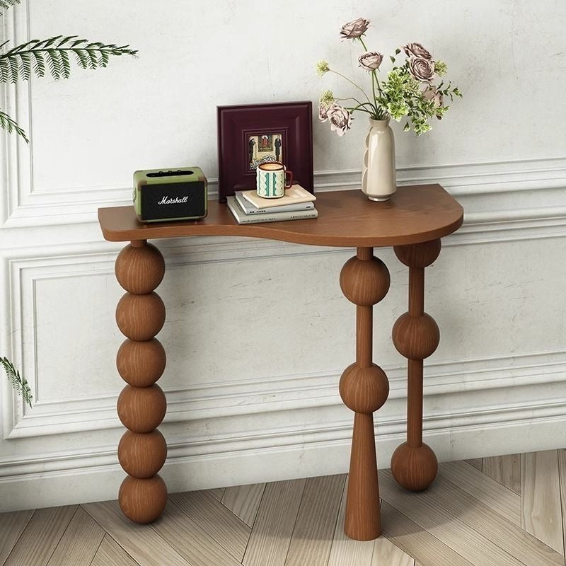 Natural wood wave-top console table showing organic curved edges and bobbin legs.