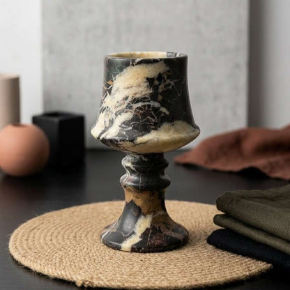 Marble-textured goblet on a woven mat with a neutral background