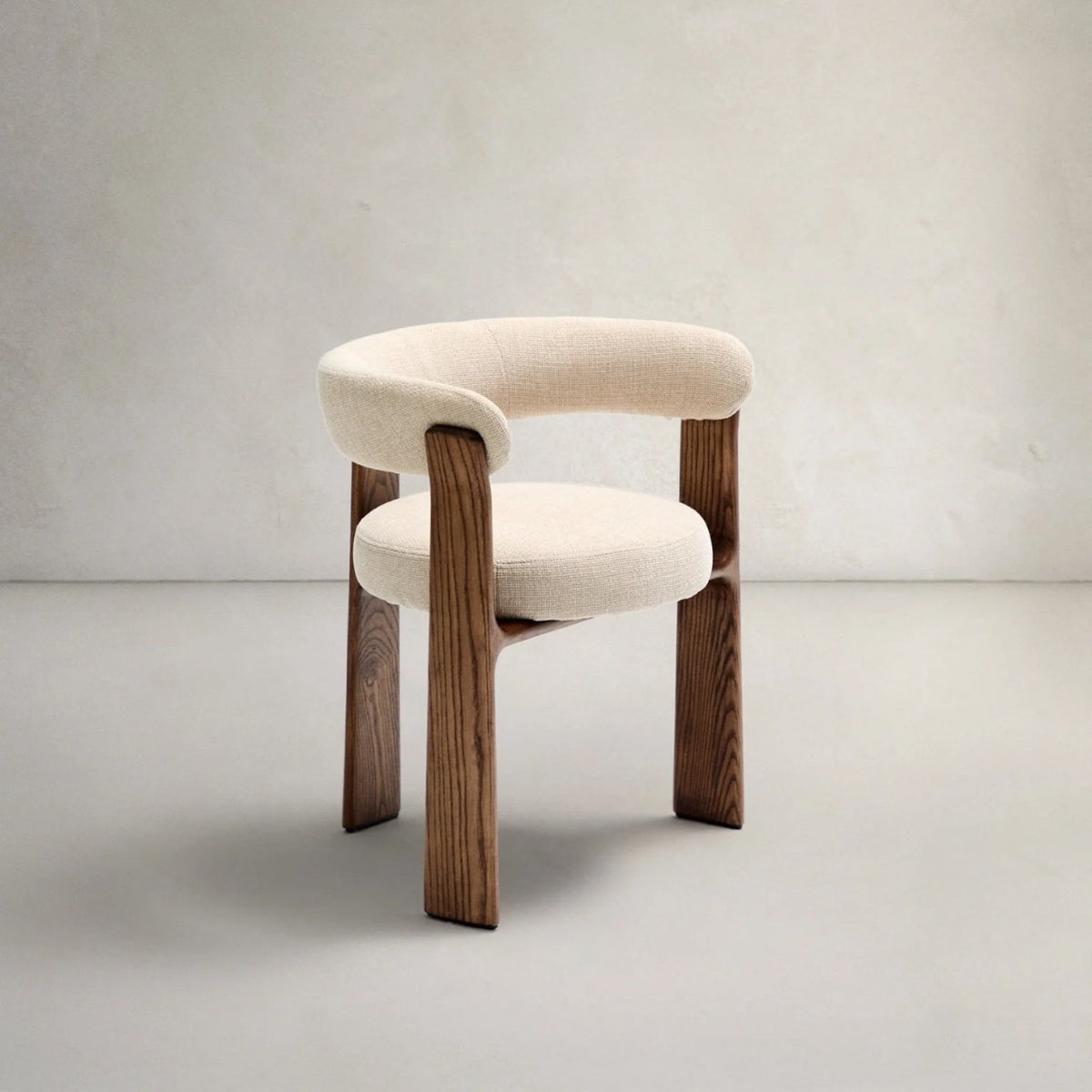 Ivory upholstered curved back dining chair with warm walnut-tone wood frame
